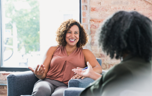 Two women talking in an office.